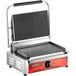 An Avantco stainless steel commercial panini grill with red handles.