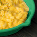 A Tablecraft green cast aluminum fry pan filled with macaroni and cheese.