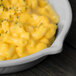 A Tablecraft natural cast aluminum fry pan filled with macaroni and cheese.