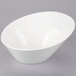 A 10 Strawberry Street Whittier white porcelain pinch bowl on a gray surface.