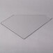 A clear plastic triangle on a counter with a white surface.