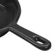 A Tablecraft black cast aluminum fry pan with a green speckle interior.