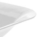 A close-up of a white Tablecraft square bowl with a curved edge.