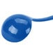 A close-up of a Tablecraft cobalt blue cast aluminum long ladle with a spoon on top.