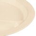 A close up of a beige Cambro polycarbonate narrow rim plate with three compartments.