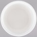 A white Tablecraft cast aluminum salad dressing bowl with a lid on a gray surface.