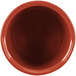 A close-up of a red Tablecraft salad dressing bowl with a brown rim.