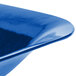 A close up of a Tablecraft cobalt blue cast aluminum square bowl with curved edges.