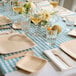 A table set with Bambu Veneerware plates, glasses, and bamboo forks.