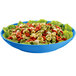 A Tablecraft sky blue pasta bowl filled with tortellini and lettuce.