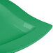 A close up of a Tablecraft square green cast aluminum platter with a curved edge.