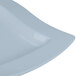 A close up of a Tablecraft square gray cast aluminum platter with a curved edge.