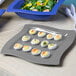 A Tablecraft granite cast aluminum platter with deviled eggs on it.