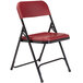 A National Public Seating black metal folding chair with a burgundy plastic seat.
