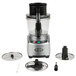A Waring commercial food processor with a blade and other accessories on a white background.