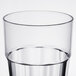A close-up of a Thunder Group clear polycarbonate tumbler full of water.
