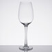 A clear Thunder Group plastic wine glass on a reflective surface.