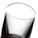 A clear Thunder Group plastic shot glass with a small amount of liquid in it.