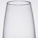 A close up of a Thunder Group clear plastic wine glass with a thin rim.