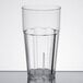 A close-up of a clear Thunder Group polycarbonate tumbler with a black rim.