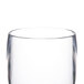 A close-up of a clear Thunder Group plastic pilsner glass.