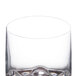 A close up of a clear plastic Thunder Group Classic Rocks glass with a heavy base.