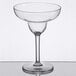 A clear Thunder Group plastic margarita glass with a stem on a table.