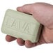 A person holding a green Lava bar of soap.