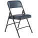 A black metal folding chair with a dark midnight blue vinyl padded seat.