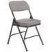 A National Public Seating black metal folding chair with a charcoal gray padded seat.