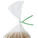 A bag of rice with a green paper tie around it.
