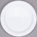 A white Thunder Group Nustone melamine plate with a white rim on a gray surface.