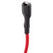 A black object with a red and black cable and red plug.