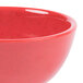 A close up of a red GET Melamine bowl.