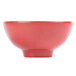 A red serving bowl with a white interior and white stripe.