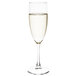 An Arcoroc champagne flute filled with liquid.