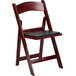 A Flash Furniture red mahogany plastic folding chair with a black vinyl padded seat.