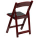 A Flash Furniture mahogany plastic folding chair with a black vinyl padded seat.