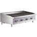 A Cooking Performance Group gas countertop charbroiler with lava briquettes and three burners.