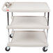 A gray Metro utility cart with three shelves and wheels.