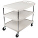 A gray Metro utility cart with three shelves and wheels.