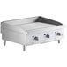 A Cooking Performance Group gas countertop griddle with stainless steel and three burners.