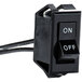A close-up of a black Nemco Rocker Switch with white text.
