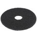 A black Scrubble by ACS 15" black stripping floor pad with a hole in the center.