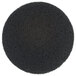 A black circle with small texture.