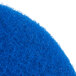 A close up of a blue Scrubble by ACS 53-15 cleaning floor pad.