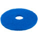 A blue Scrubble cleaning floor pad with a hole in the middle.