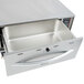 A stainless steel APW Wyott drawer warmer open on a counter.