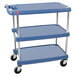 A blue three tiered Metro utility cart with wheels.