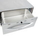 A stainless steel APW Wyott drawer warmer on a counter with the drawer open.
